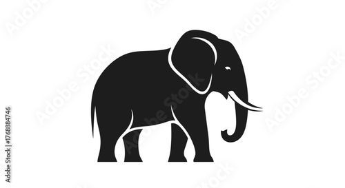 A monochrome silhouette of an elephant standing, showcasing its distinctive features like large ears.