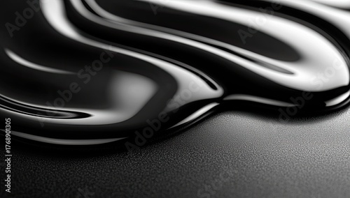 Dark glossy liquid forms a slick, reflective abstract
