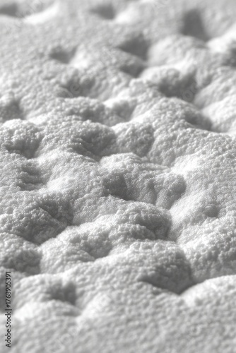 Textured, bumpy surface, soft gray scale, close-up view