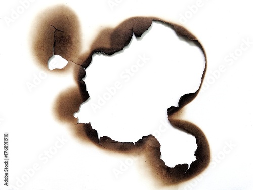 Canvastavla Close up of fire burned hole on white paper background