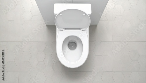 White ceramic toilet with an open lid from a top-down view on a modern hexagonal tiled floor.