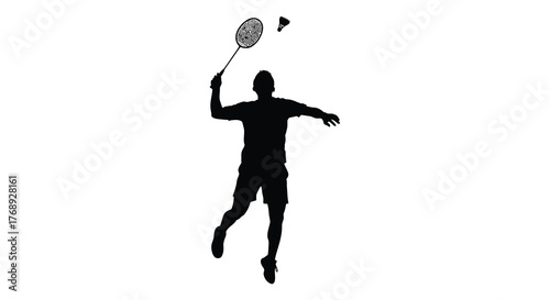 Dynamic silhouette of a male badminton player in mid air hitting a shuttlecock with a powerful overhead smash silhouette