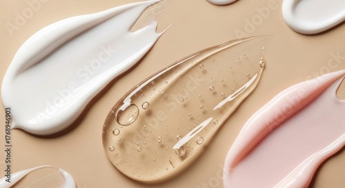 Swatches of various cosmetic products, featuring creamy white lotion, clear gel with bubbles, and a pale pink cream arranged against a neutral, warm background, showcasing textures.