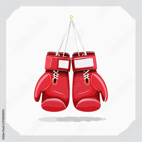 A pair of red boxing gloves hanging from white strings, ready for a match.