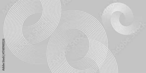 Abstract image composed of multiple layered circles on a light grey background. The circles are layered with delicate lines