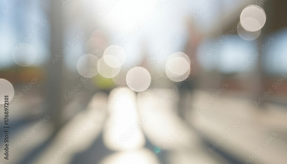 Fototapeta premium Soft abstract scene of bright sunlight forming circular bokeh along an outdoor pathway, blending warm natural tones with a dreamy glow that captures calm movement and gentle light.
