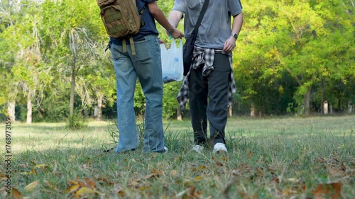 young people collecting garbage in park