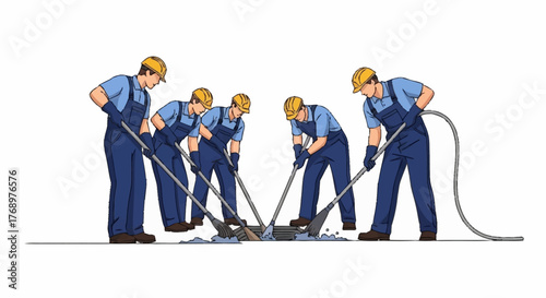A team of construction workers in blue overalls and yellow hard hats collaboratively using shovels to break up and remove concrete pavement.