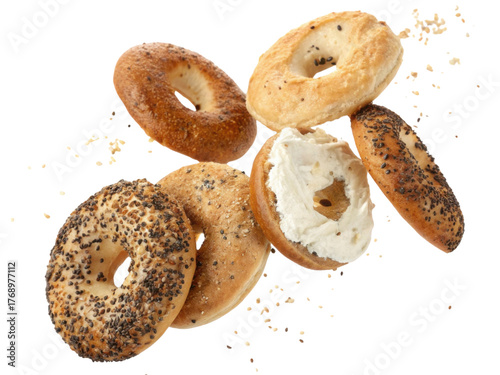 Delicious fresh baked poppy seed and plain bagel with cream cheese spread. satisfying breakfast food snack isolated transparency background