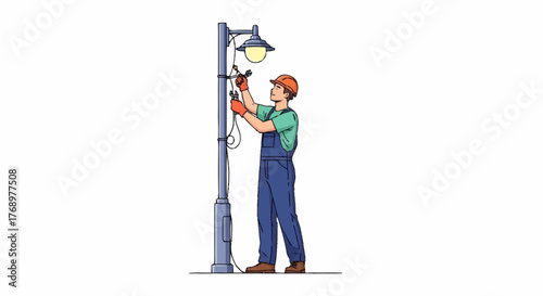 A male electrician in an orange hard hat and blue overalls performs maintenance on an illuminated street lamp.