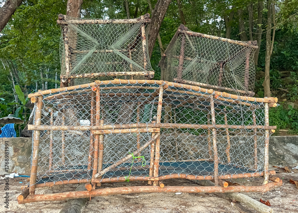 Fototapeta premium New wooden traps with metal mesh used by local fishermen to catch crabs and fish in the coastal waters of Phuket.