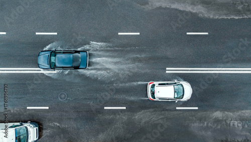 road traffic in rainy weather. cars driving on flooded street after heavy rain. dangerous driving conditions. aerial panoramic view.