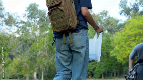 young people collecting garbage in park