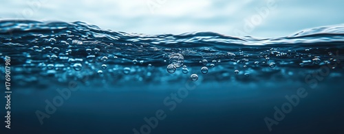 Deep blue water with bubbles near the surface
