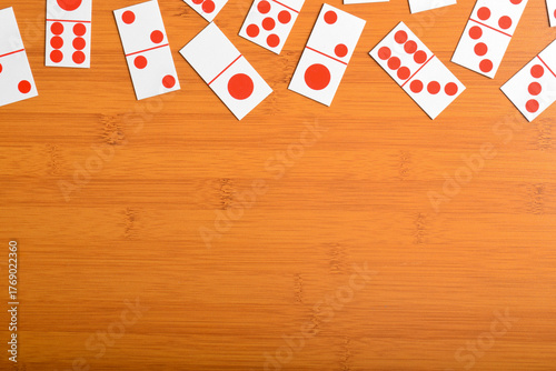 Domino pieces on a brown wooden table with copy space