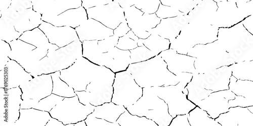 Cracked dry soil texture in high contrast black and white. Abstract pattern symbolizing drought, arid land, and environmental damage. Perfect for design, background, and texture projects.