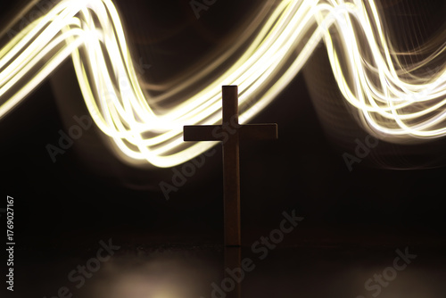 Fotografía Silhouette of Cross with Dynamic Light Trails in the Background Symbolizing Spir