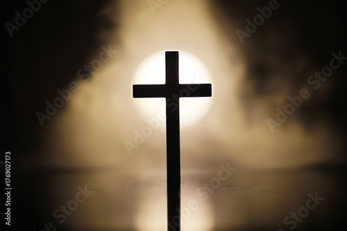 Bild auf Leinwand Silhouette of Cross Against Defocused Sunlight Background, Symbolizing Faith and