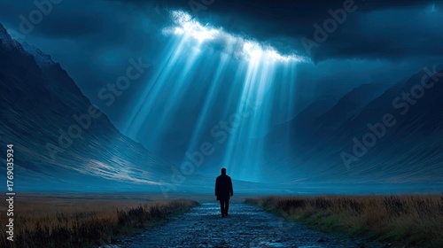 A man walking through a dark valley toward the heavenly concept. A solitary figure walking in a dramatic, moody landscape.