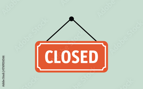 Orange closed sign hanging on a light green background