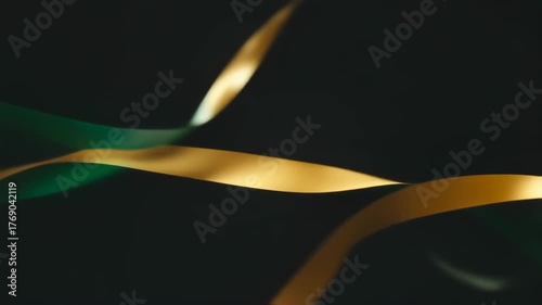 Abstract design of overlapping, wavy ribbons in teal and gold, against a dark background