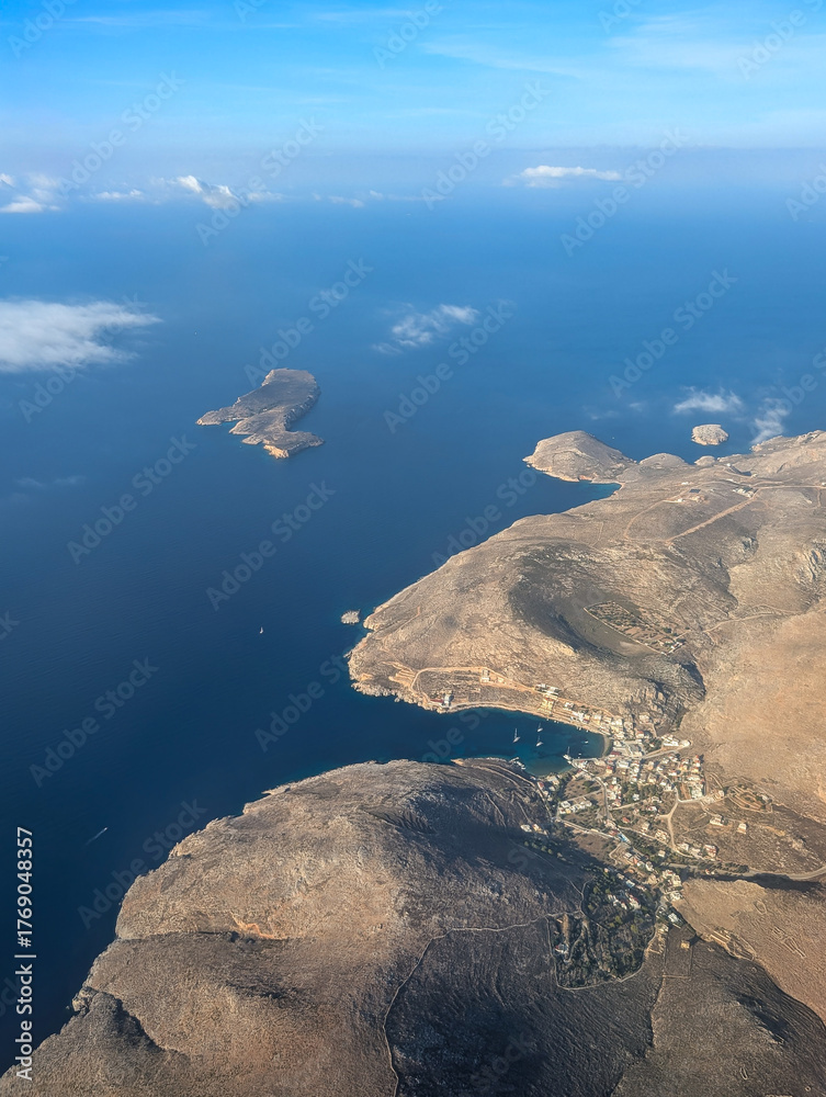 Obraz premium Aerial view of the Greek island of Kalymnos in the southeastern Aegean Sea. Photo taken from the airplane window during the flight from Munich to Kos