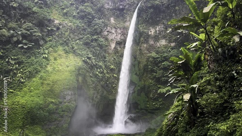 view of Pelangi Waterfall in Malang, east java, Indonesia. Stunning jungle scene with cascading streams and lush green tropical vegetation