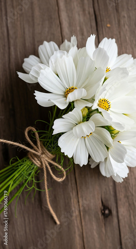 White Cosmos Flowers Tied with Twine on a Wooden Surface white flowers bouquet