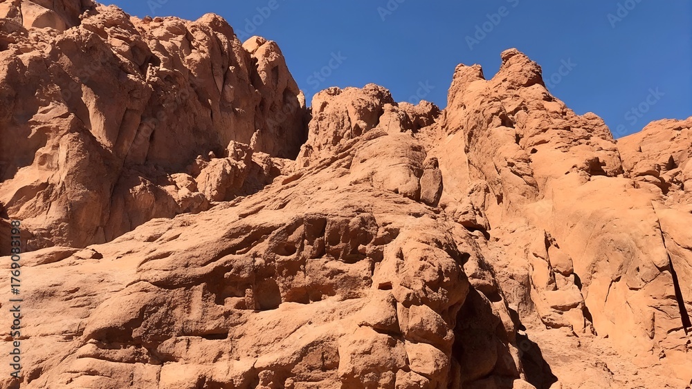 Fototapeta premium Red rugged rocky cliff texture background