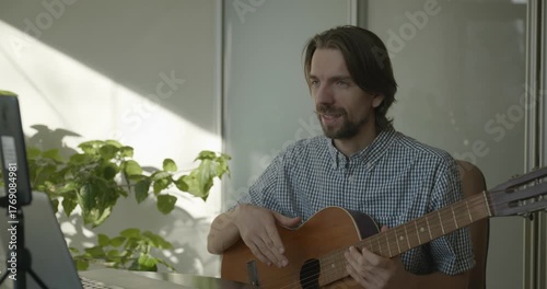 Musician Teacher Teach Guitar Lesson Online Using Laptop. 4K 10-bit