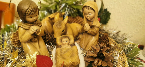 Representation of the nativity with three figures: Jesus, a baby and a donkey, symbolizing the Christmas story in a classical context