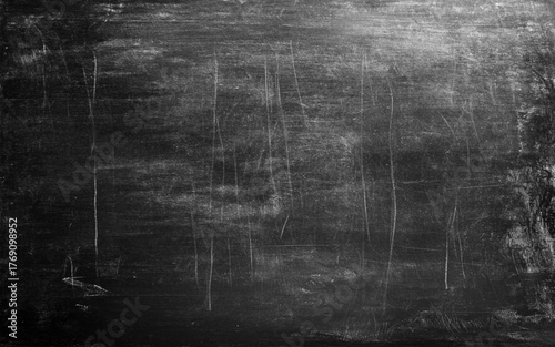 Chalk rubbed out on blackboard photo. Black wall. 
