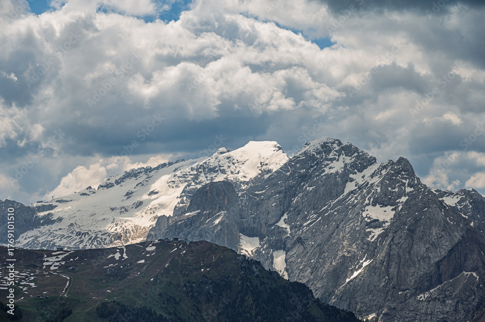 Obraz premium Sella mountain range and Sasso Pordoi images from Col Rodella with a cloudy sky in the background, Dolomites, Italy