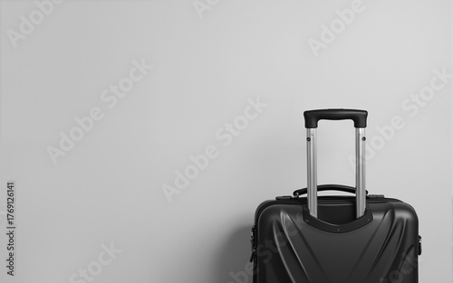 Luggage bag closeup background, travel minimalist concept in classic black and white colors. Baggage cabin size trolley, grey blank background with space for text, vacation trip, luggage suitcase.