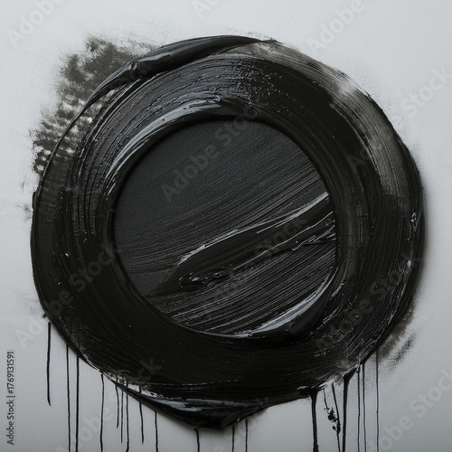 A circle painted with black paint. Geometry, shape, expression. Dripping paint. Shiny surface.