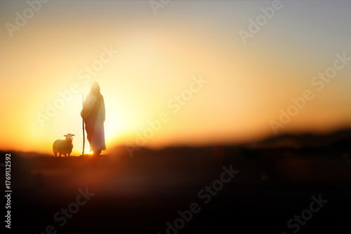 Jesus Christ, a shepherd walking with sheep on a meadow, Christian Jesus background
