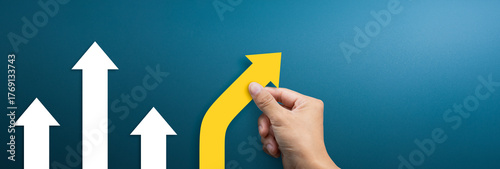 Business concept for new ideas creativity and innovative solution. Group of arrows in one direction and businessman hand holding arrow pointing in the different way, copy space