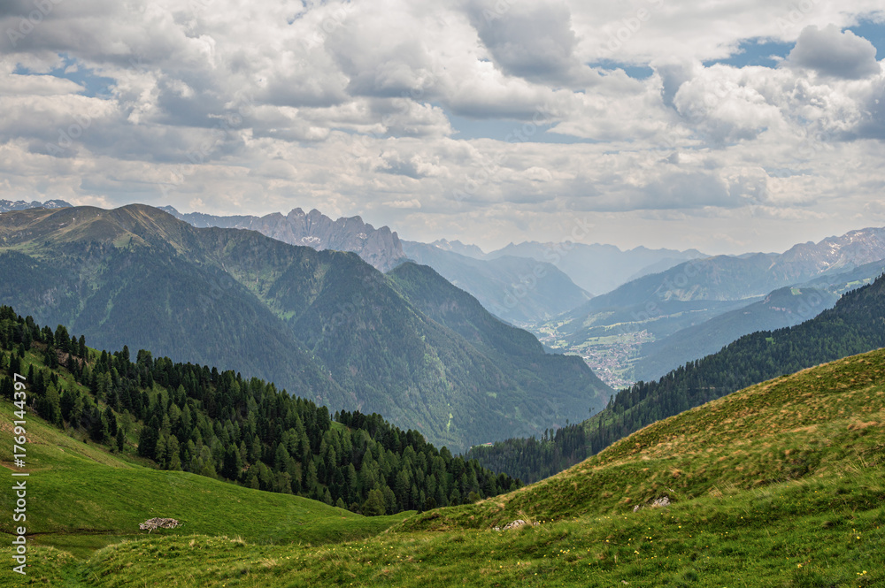 Fototapeta premium Sella mountain range and Sasso Pordoi images from Col Rodella with a cloudy sky in the background, Dolomites, Italy