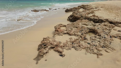 Atlantic Ocean waves breaking over a volcanic rock shoreline of the Cape Verde island of Boa Vista.