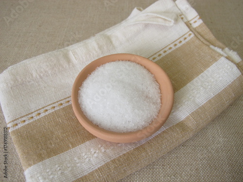 Epsom bath salt in a ceramic bowl on a towel