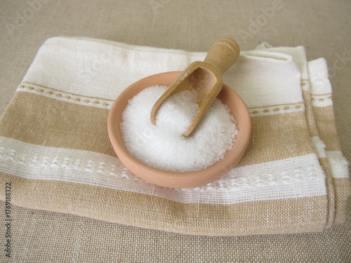Epsom bath salt in a ceramic bowl on a towel