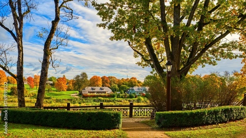 Picturesque autumn landscape with the Venta Rapid, Europe's widest waterfall, in Kuldīga, Latvia. The Venta River flows over the dolomite rapids, surrounded by colorful fall trees 