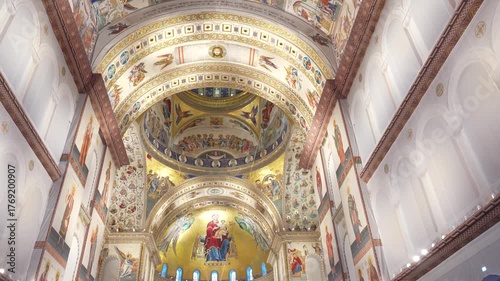 Interior of the People’s Salvation Cathedral in Bucharest, Romania. Majestic Orthodox cathedral with grand arches, golden mosaics, marble columns, and intricate religious frescoes