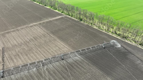 Aerial View of Pivot Irrigation System Watering Fertile Farmland. Modern Agriculture Technology for Sustainable Crop Growth and Soil Hydration