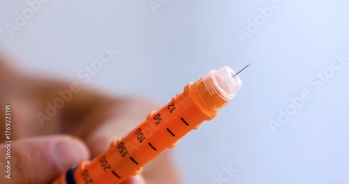 Insulin Flowing from Orange Insulin Pen Tip in 4K Slow Motion
