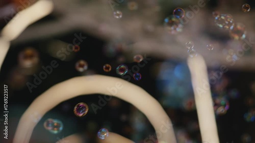 Colorful bubbles float gracefully outdoors