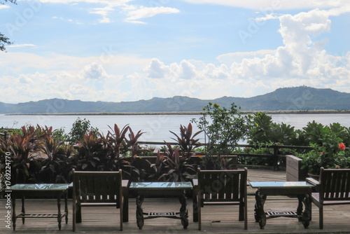 Dining tables and chairs at a restaurant on the banks of the Irrawaddy River in Myanmar