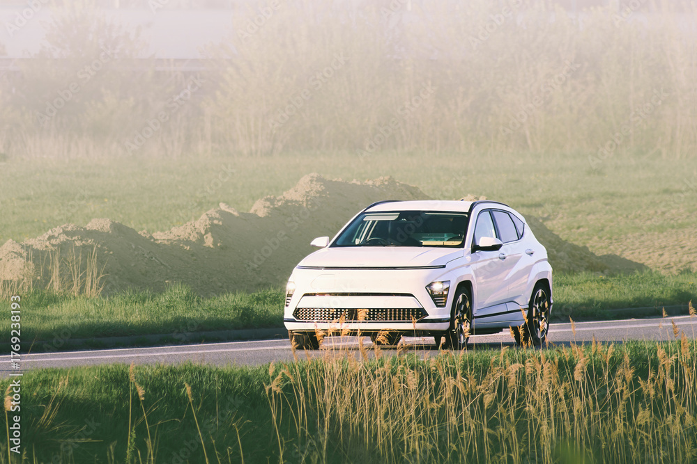 Fototapeta premium Zero emission electric car drives open road