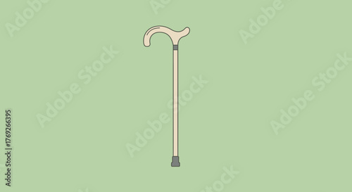 Beige cane with curved handle on a light green background