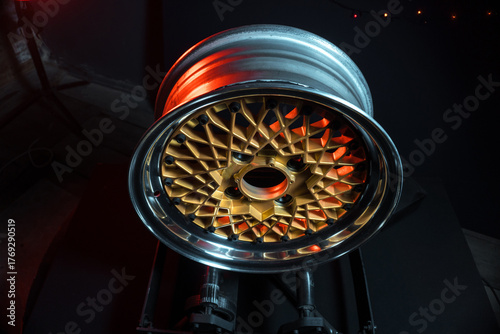 old retro stylish wheels collapsible two-component with a gold center and shiny rims for car tuning long exposure photo to simulate movement